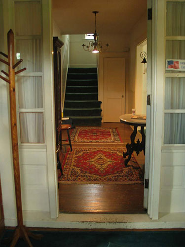 This is the view to the back of the house from the front door. To the right is the dining room/kitchen, to the left is the living room.